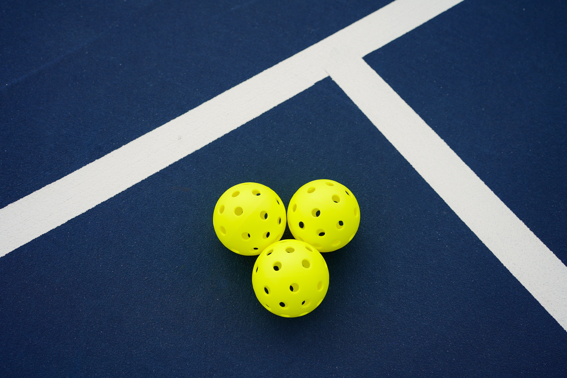 Pickleballs on court
